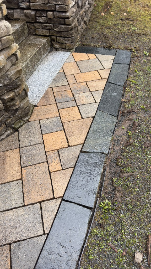 Stone patio surface with dark border stones