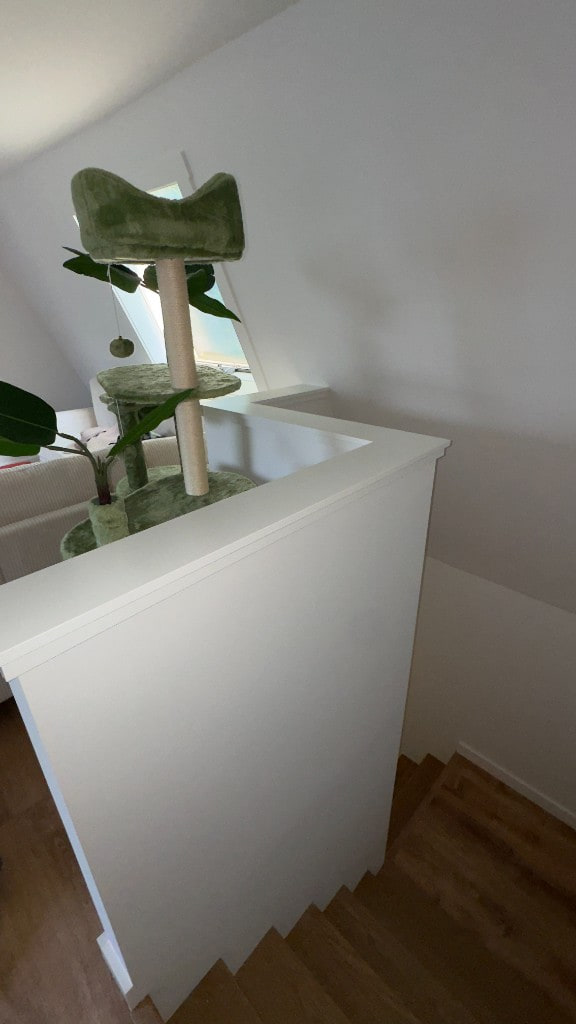 Freshly painted white half-wall and stairs in a bright interior