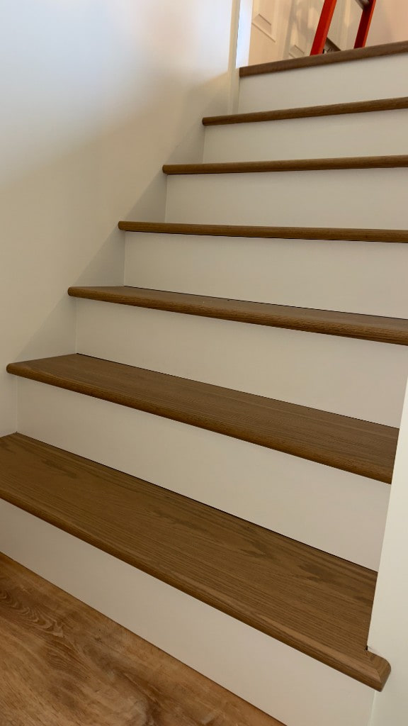 Staircase with wood treads and crisp white painted risers