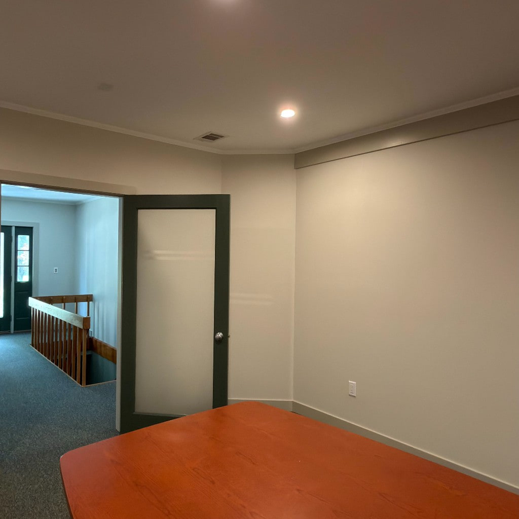 Interior room with green walls, frosted glass doors, and recessed lights