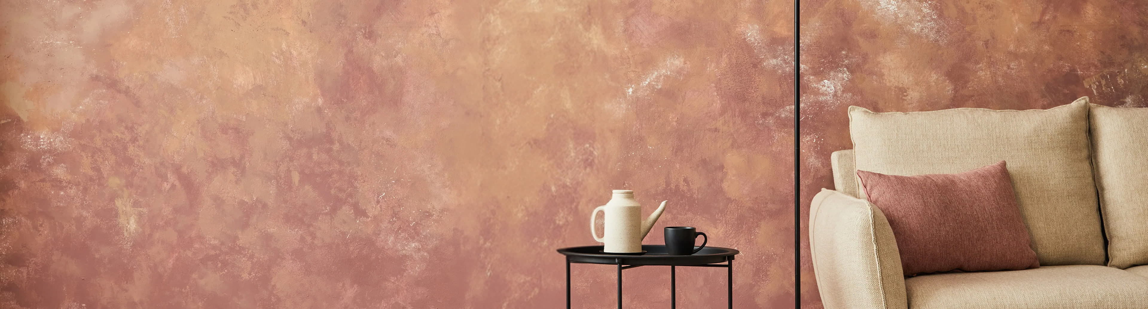 Palette knife spreading a thick glaze finish on a wall