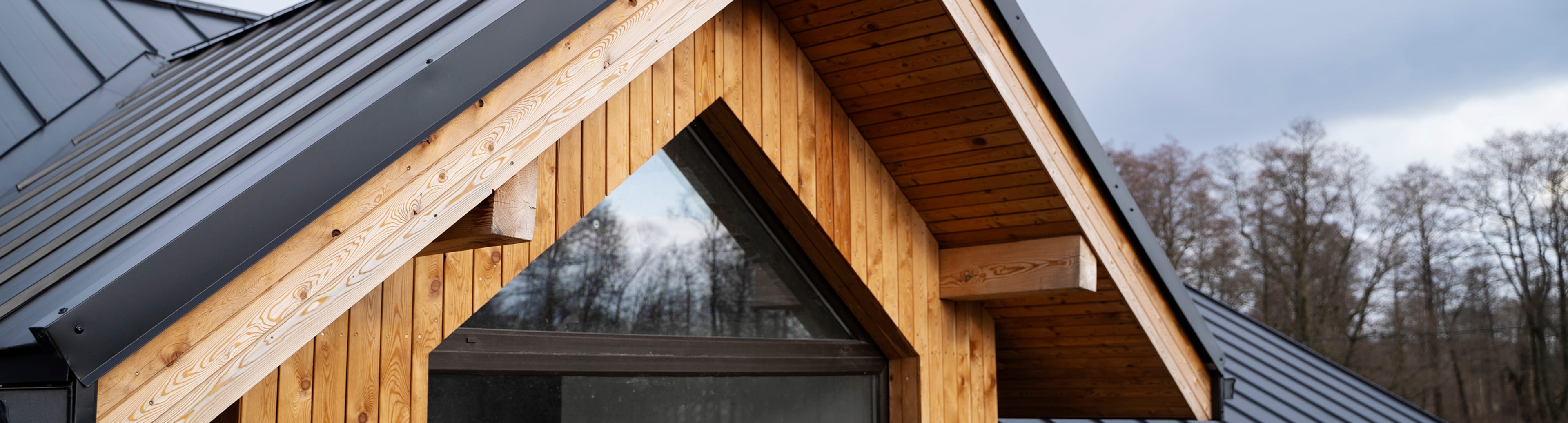 Standing seam metal roof and wood gable detail
