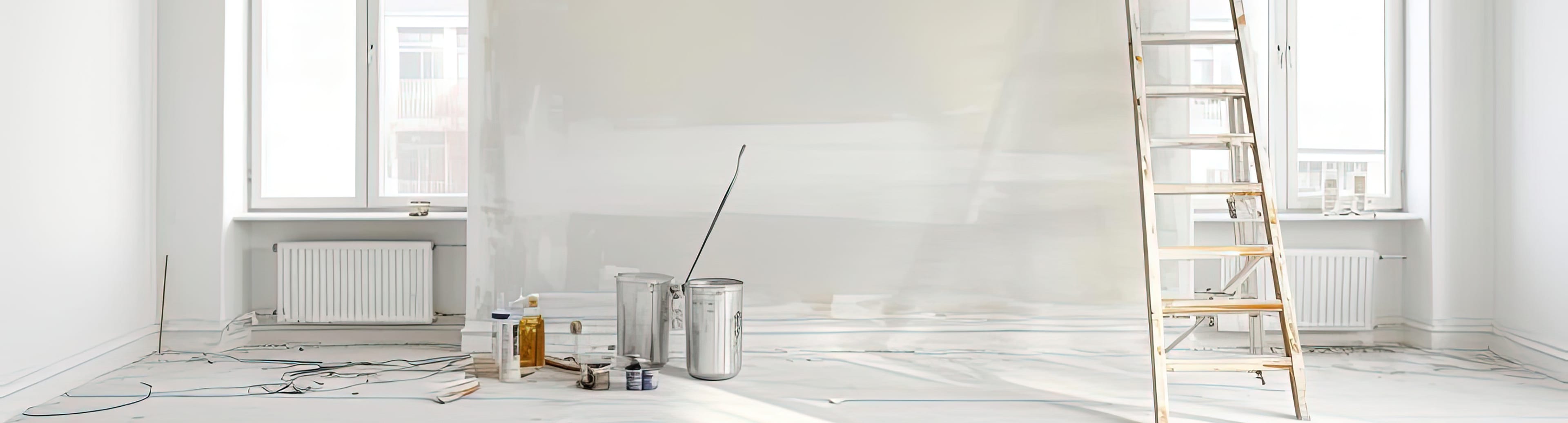 Paint cans and a ladder in a room ready for finish work