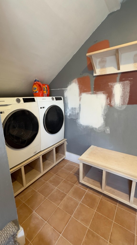 Laundry and mudroom with unfinished wood and paint samples before painting