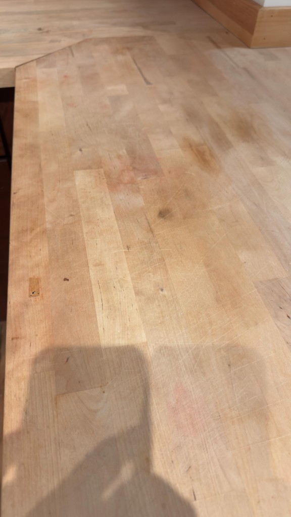 Scratched butcher-block countertop before refinishing