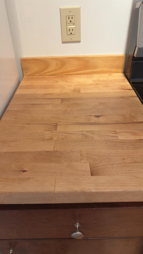 Butcher-block kitchen counter after refinishing by Servidori Painting