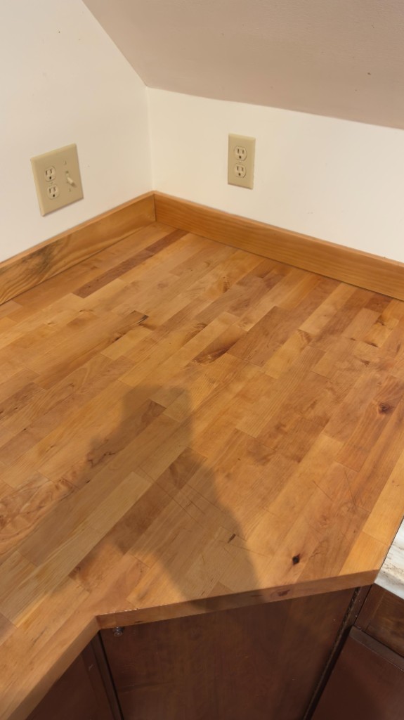 Butcher-block countertop corner after refinishing by Servidori Painting