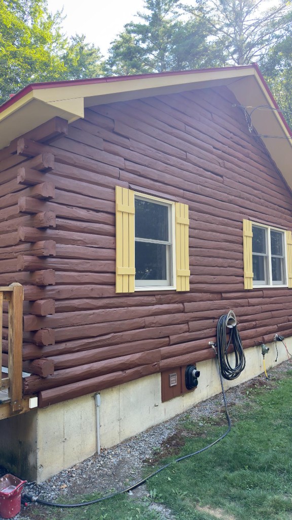 Log cabin side after exterior painting by Servidori Painting
