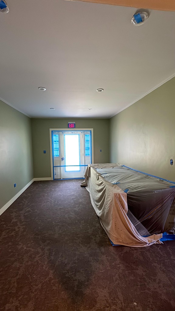 Sage green office hallway masked for painting