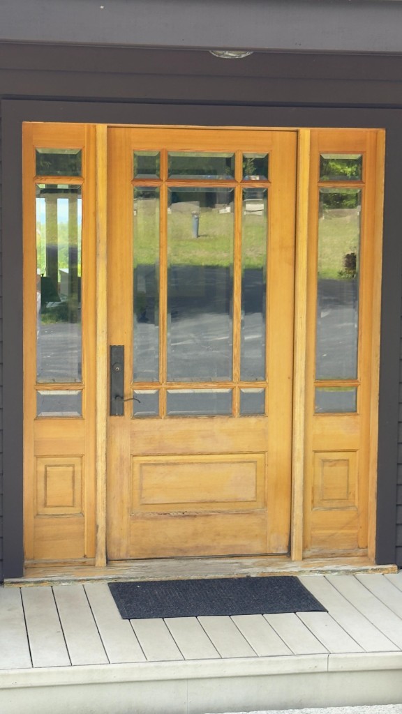 Weathered wood front door and sidelights before refinishing