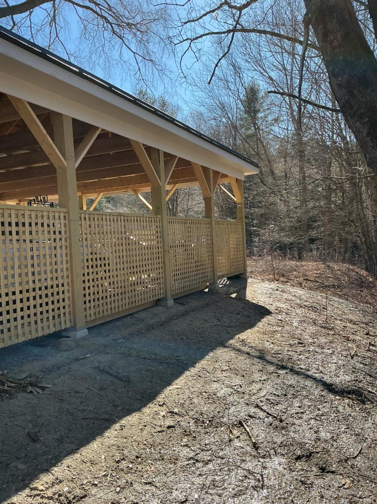 Unpainted wooden pavilion posts and braces before painting