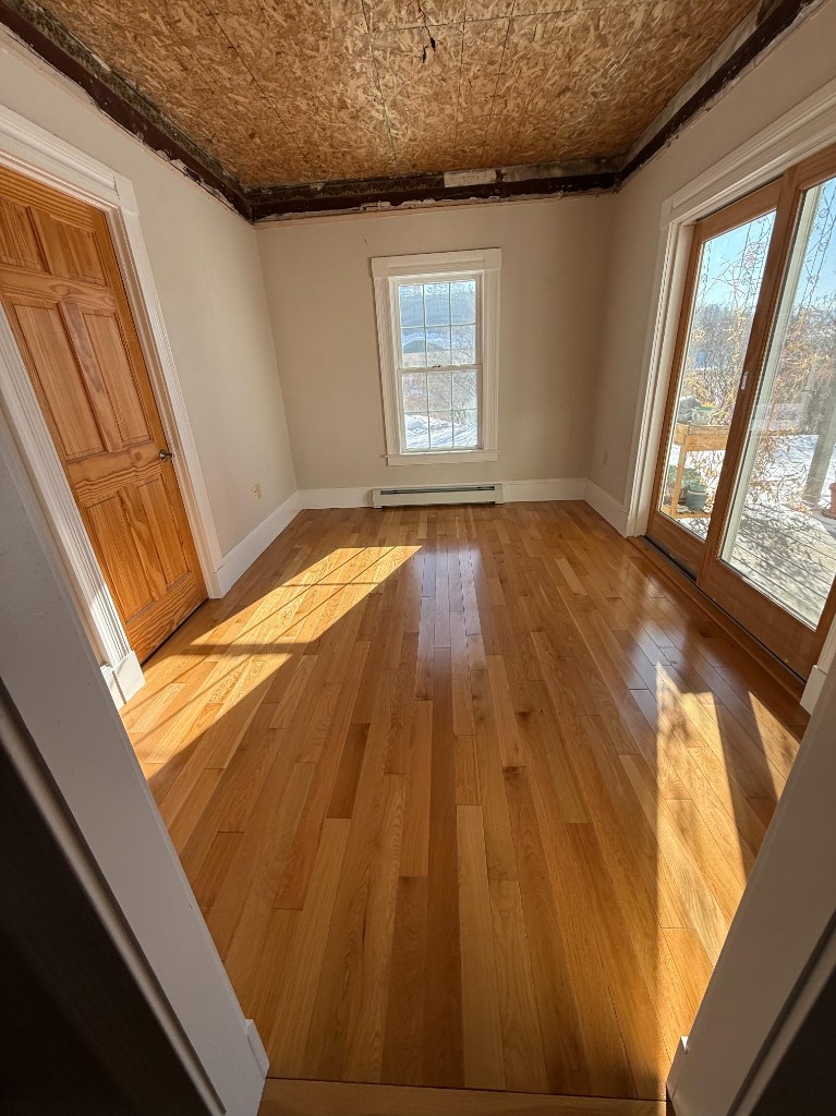 Bedroom with exposed OSB ceiling before interior finish