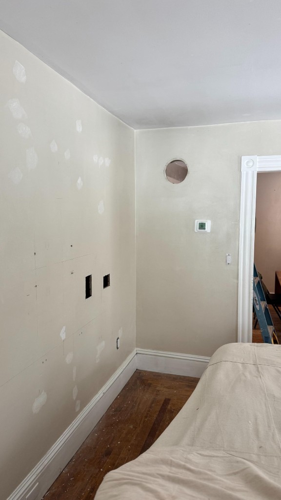 Bedroom corner with spackle patches before painting