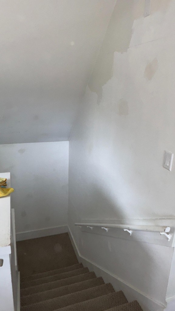 Stair hall walls with plaster patches before painting